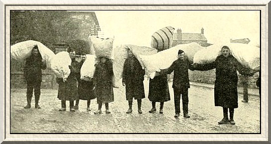 Recruits of the Lancashire Regiment carrying their beds through a
Wiltshire village to their camp.