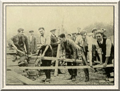 Recruits build their own huts. Cambridge University men busy with
the saw.