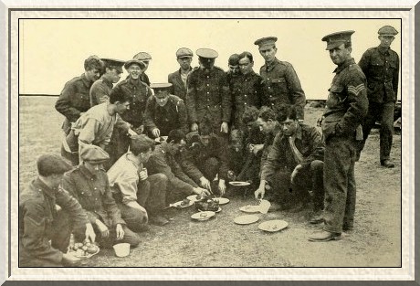 Kitchener's Army had nothing to complain about in the matter of
rations; the above is a typically happy group at dinner-time.