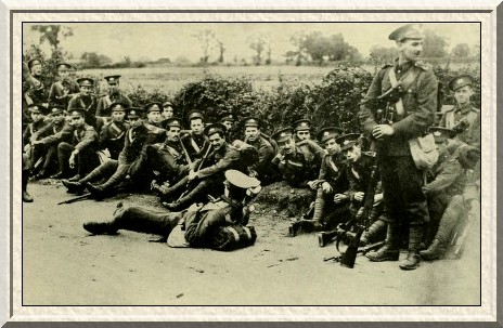 Men of the South Midland Brigade taking a welcome rest on a march.