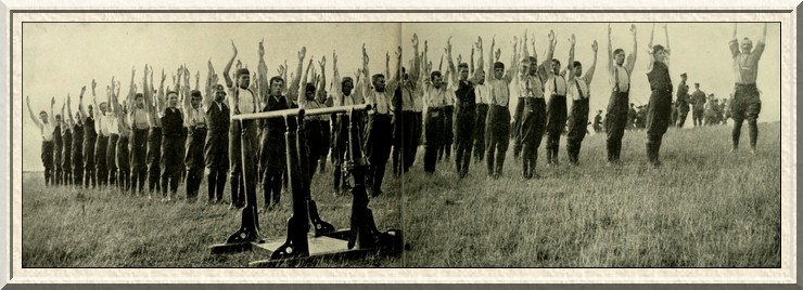 'Hands up!'—but never to the Germans! Recruits performing a
drill which will bring them to fighting fitness.