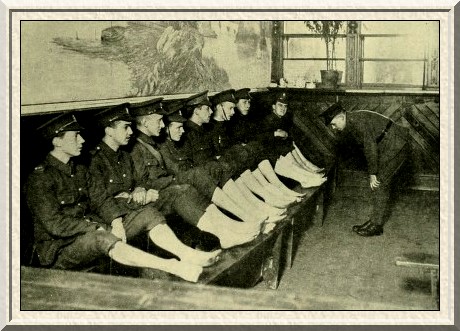 Recruits have their feet examined after a route march.