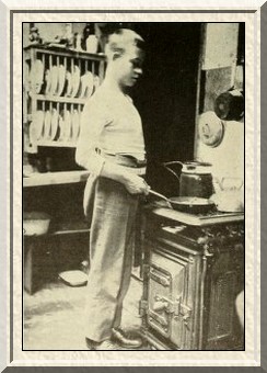 Making himself at home in a billet—A recruit cooking his
dinner.