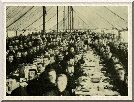 Men of the 70th Infantry Brigade, in training at Frensham Park,
having dinner in a big marquee.