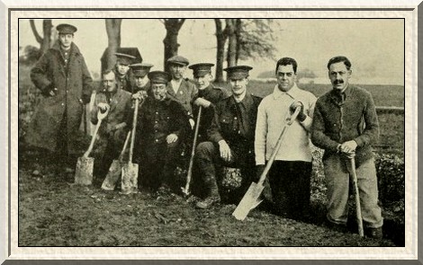 Trench-digging is hard work, but the men in training go about it
with light hearts.