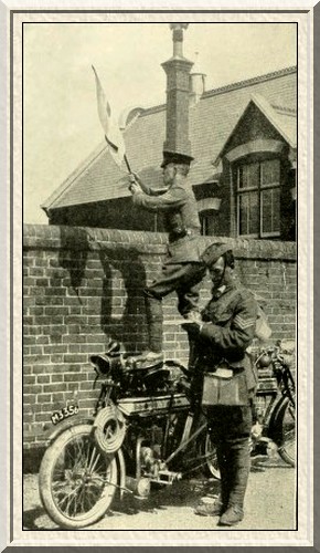 A motor-cyclist scout and a despatch-rider at signalling practice.