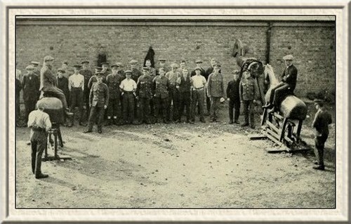 The cavalry recruits take their first lessons in horsemanship on
wooden steeds.