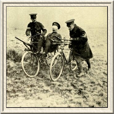 A wounded man being brought in supported by two rifles placed
between a couple of bicycles.