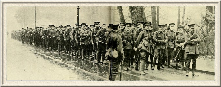 Queen's Westminsters march from London to Watford. The photograph
shows them falling in after a short halt.